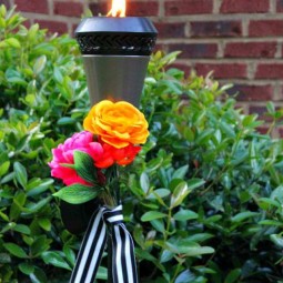 Dress up your tiki torches. These floral tiki torches would be gorgeous for a wedding or garden party. Add a few faux flowers and some striped ribbon and you are done! by Uncommon Designs