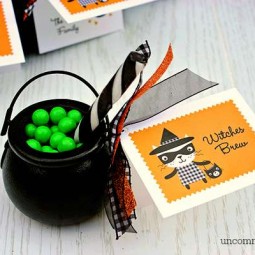 We decided to make witches brew treats out of miniature cauldrons and candies. We were able to pick up all of the supplies at our local craft store which was so convenient. We needed green Sixlet candies, miniature cauldrons, black and white striped candy sticks, and various ribbons. First, we tied the cards on to the handle of the cauldron with a fun assortment of Halloween ribbons, then we filled it up with the green candies for our brew and used the candy stick as our wooden stir stick. That is it… so cute and so easy! These make perfect classroom treats, too!