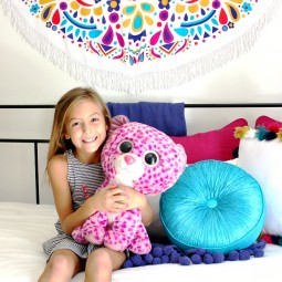 Boho Girls Room with Benjamin Moore's Simply White, a colorful wall hanging, daybed with loads of gorgeous pillows | Uncommon Designs